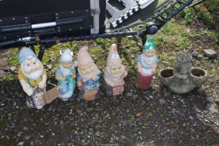 Five garden gnomes and a concrete Donkey.