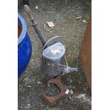 Galvanised watering can, stirrup pump and parts of a shoe last.