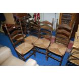 Five ladder back chairs.