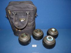 A set of Thomas Taylor Lawn Bowls in a carrier.