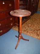 A Walnut/Mahogany circular wine/lamp table having turned pillar and three splay feet,