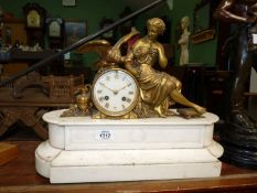 An ornate Mantle clock depicting a seated lady with eagle on white polished stone base, some damage,