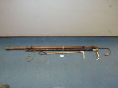 A horn handled walking stick, cane crop and a fishing hook.