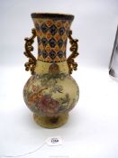 A large oriental vase with gold coloured handles and raised floral detail. 13 1/2" tall.