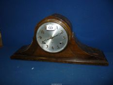 A dark-wood cased cheval design Mantel Clock having a two-train movement striking on bar gongs,