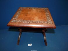 A small occasional Table having floral carved detail to the top, 12" square x 11 1/2" tall.