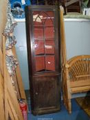 A full height Dark Mahogany Corner cabinet on cupboard having Gothic and shaped glazing,