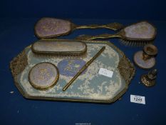 A Dressing Table set comprising tray, mirror and brushes the backs having lace on a mauve ground.