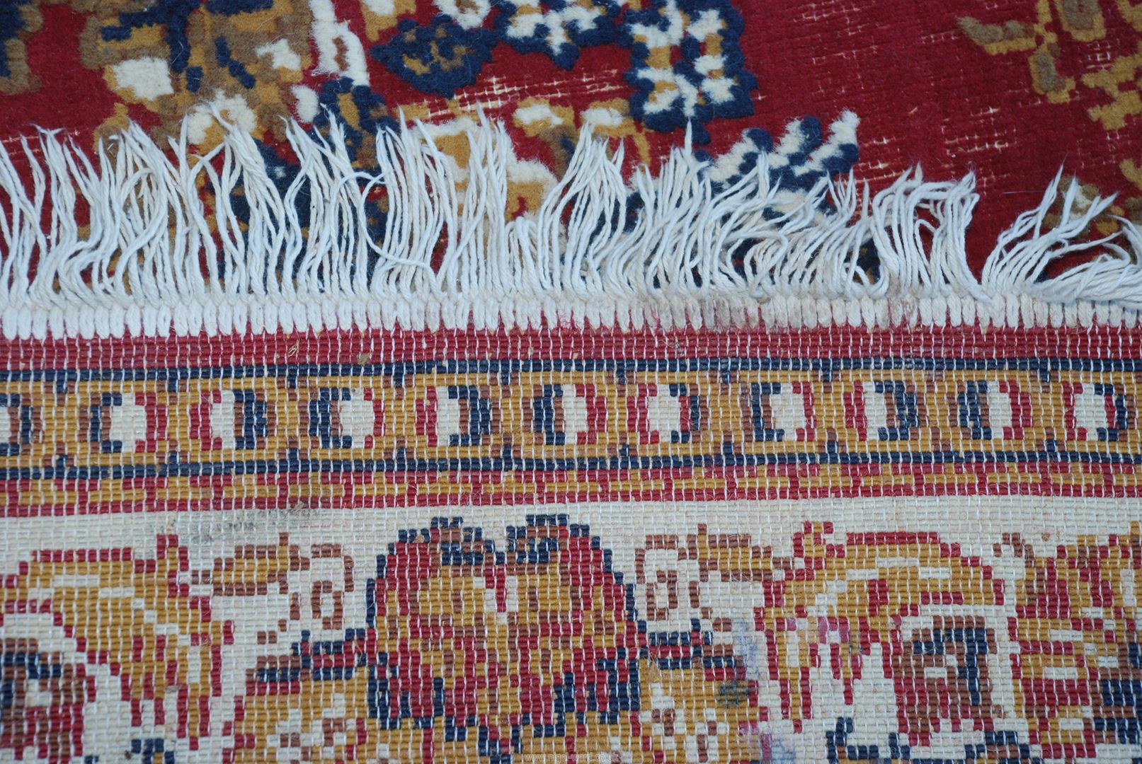 A red and cream patterned rug, 75" x 110", well worn. - Image 3 of 3