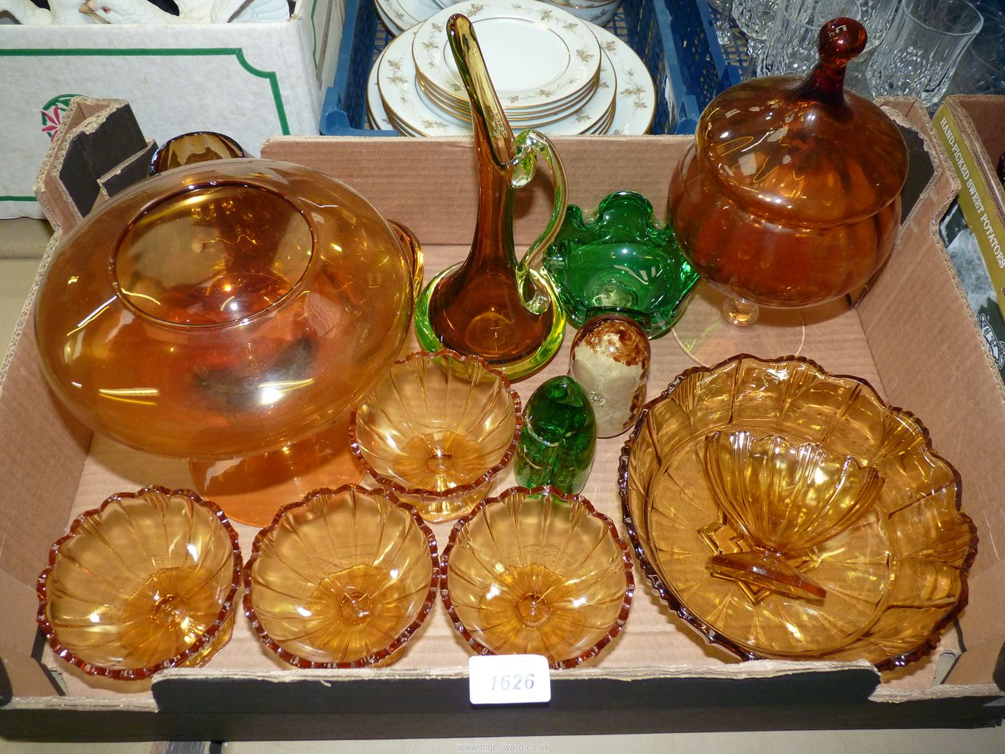 A quantity of amber coloured glass including a fruit bowl with five fruit dishes, orange jug,