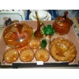 A quantity of amber coloured glass including a fruit bowl with five fruit dishes, orange jug,