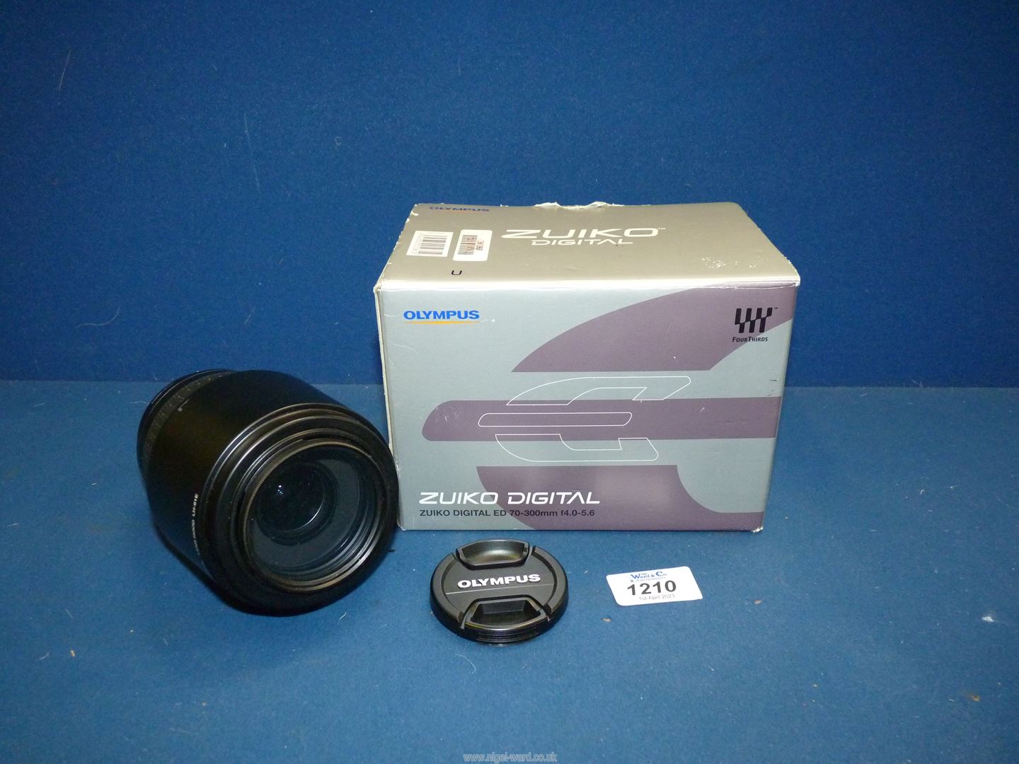 An Olympus Zuiko Digital ED 70-300mm f/4-5.6 Zoom Lens, boxed with Caps and Lens Hood.