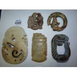 Five small oriental flat carved stone animals including dragon/serpents, etc.