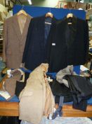 A quantity of gent's dinner jackets, trousers with braces, waistcoats, pinstripe trousers,