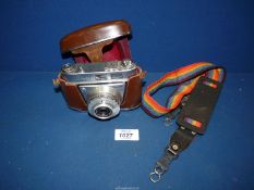 A Kodak Rettinette A1 camera in fitted leather case and rainbow strap.