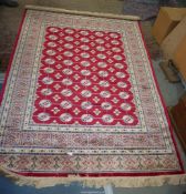 A red ground Cashmere Bohkara? design rug, 190cm x 140cm.