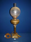 An Oil lamp converted to a side lamp having brass classical pillar, etched shade,