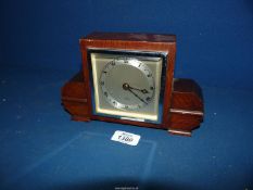 An oak cased Art Deco design square faces mantel clock having silvered chapter ring with Roman