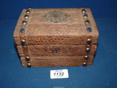 A Black Forest lidded box in the form of a small chest with blue polished stones to the banding