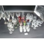 A quantity of glasses including coloured liqueur, cranberry, smoked, custard cup etc.