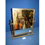 A 19th c brass framed Swing Mirror on mirrored stand with ball feet, 14'' x 12''.