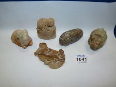 Five small oriental carved soapstone animals including goat, mythical figures, etc.
