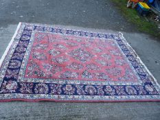 A blue and pink ground rug with floral motif, a/f., 8' 4" x 6' 8".