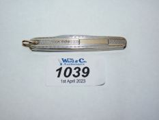 A Silver and gold coloured twin blade Penknife with engine turned decoration,