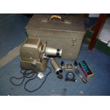 An Aldis slide projector in case with extension lens.