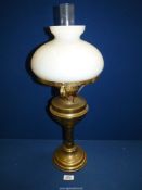 A Victorian brass oil Lamp with white shade and clear chimney, 24" tall.