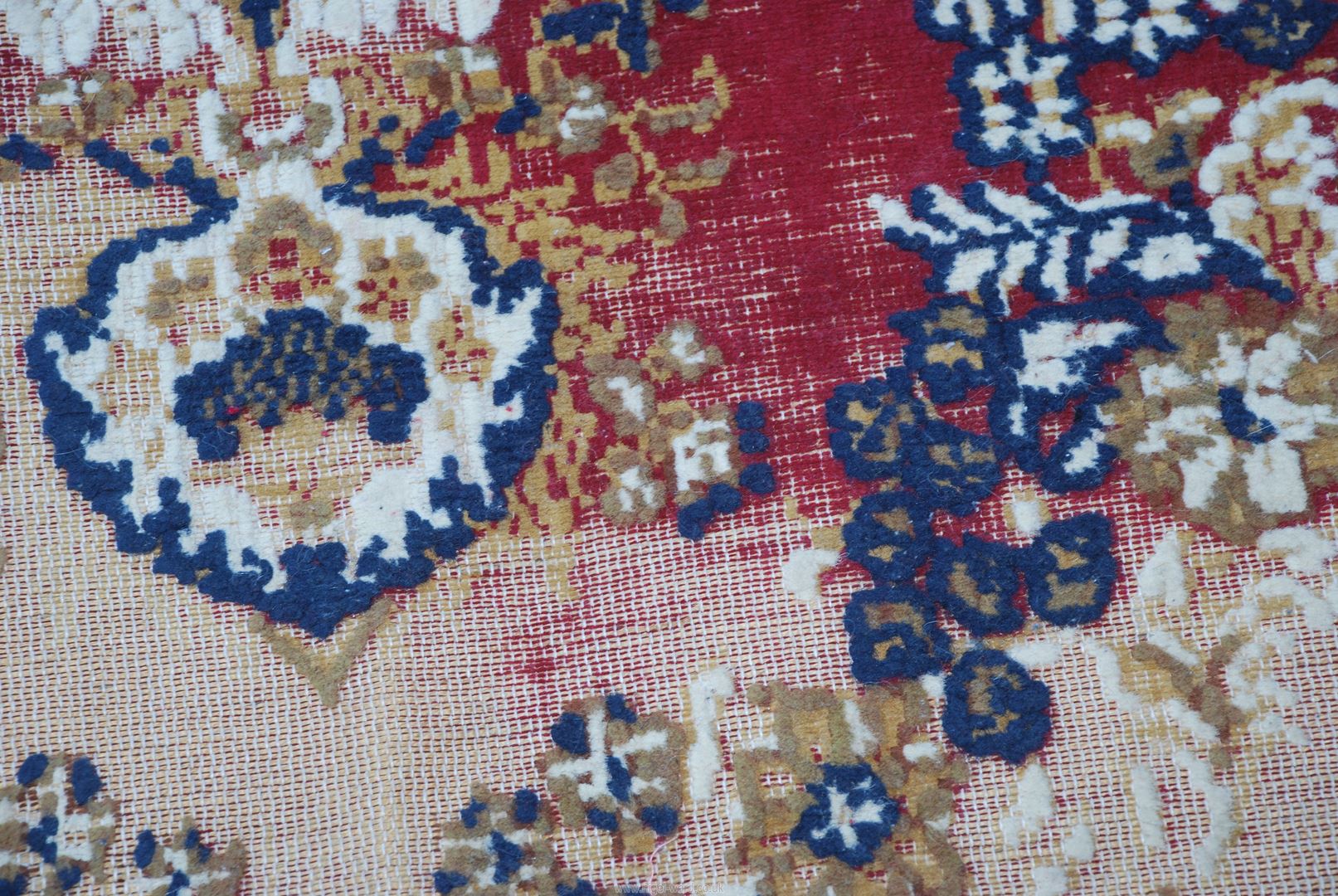 A red and cream patterned rug, 75" x 110", well worn. - Image 2 of 3