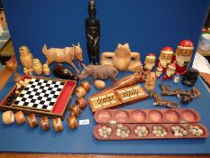 A quantity of treen to include Russian Dolls, carved goats and frog, Tunbridge napkin rings,