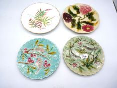 Four Majolica style plates to include two birds and berries 9" plates, and two floral 8" plates.