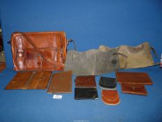 A quantity of assorted leather wallets, brown leather shoulder bag, etc.