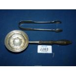 A Silver tea Strainer with turned wooden handle and sugar tongs, (39 gms) London.