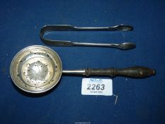 A Silver tea Strainer with turned wooden handle and sugar tongs, (39 gms) London.