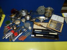 A quantity of plated items including cutlery, jugs, teapot etc.