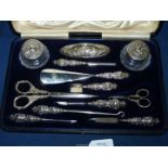 A Silver Manicure Set in blue velvet lined presentation case, Birmingham 1904,