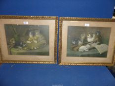 A pair of gilt framed prints of cats around a violin and cats on an artist's table,