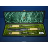 A boxed Carving set by Wheatley Brothers, Sheffield, the case having green velvet interior.