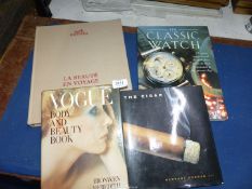 Four books including 'The Cigar', 'The Classic Watch', 'Vogue' and 'La Beaute En Voyage'.