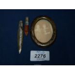 A miniature oval Silver frame, lacking back and a Silver pencil, Birmingham, 18.2 gms.