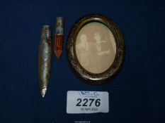 A miniature oval Silver frame, lacking back and a Silver pencil, Birmingham, 18.2 gms.