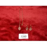 A pendant and earring set in an inter linking design (unmarked,