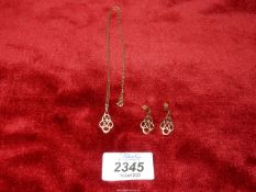 A pendant and earring set in an inter linking design (unmarked,