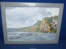 A framed Oil on canvas of a coastal scene with boats being winched ashore and houses on a steep
