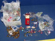 A large quantity of individually bagged beaded necklaces and bracelets.