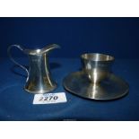 A James Dixon & Sons Sheffield Silver egg cup 1943, 74 gms, plus a miniature Silver jug,