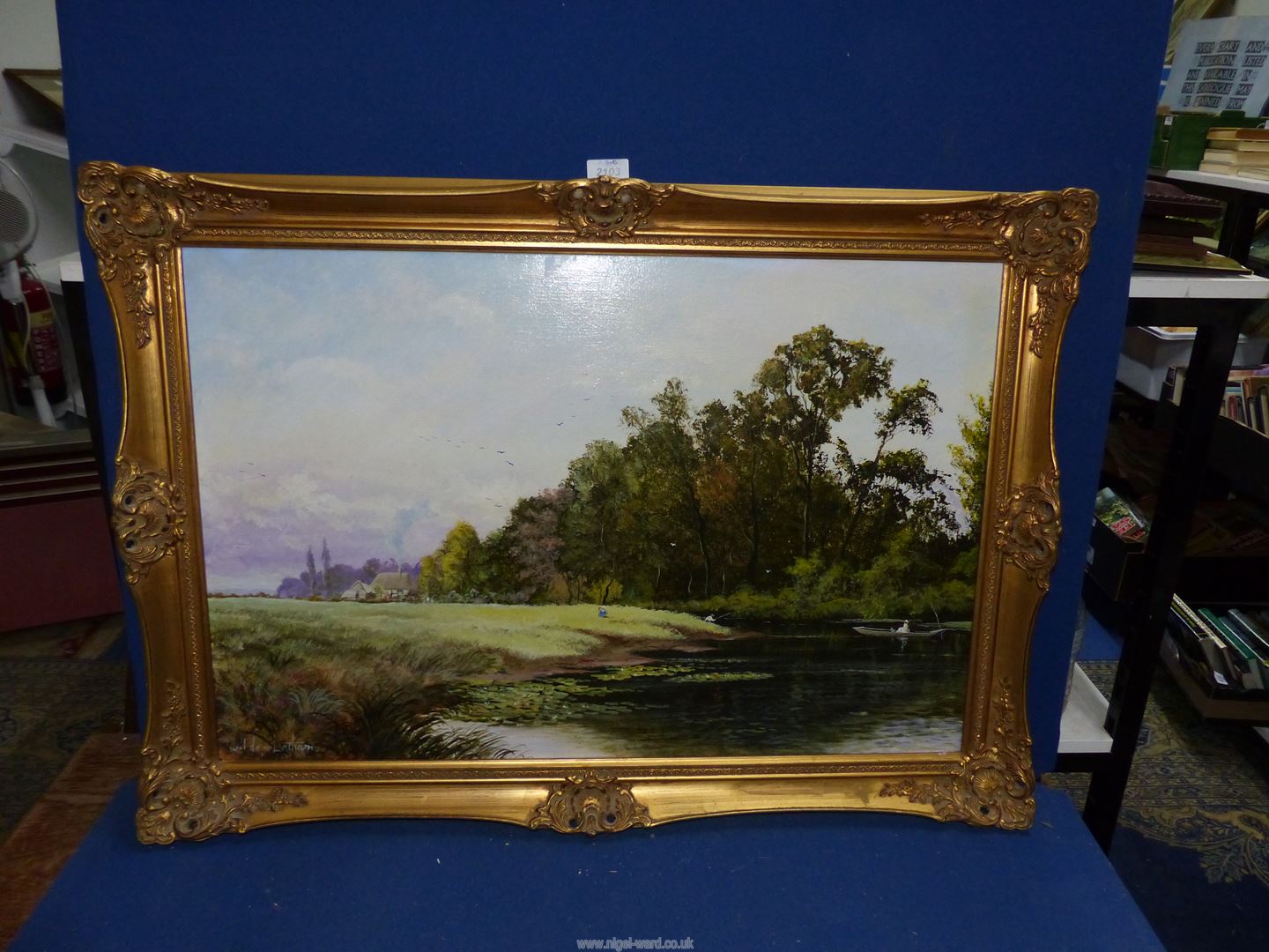 A large gilt framed Oil on canvas of a river scene with gentlemen fishing and figures in a punt,