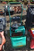 A Qualcast cylinder mower, petrol engined, with grass box.